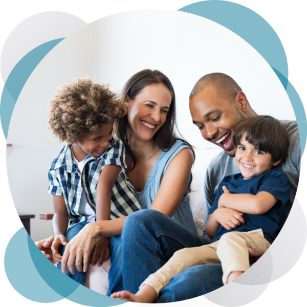 A family of four sitting on the couch