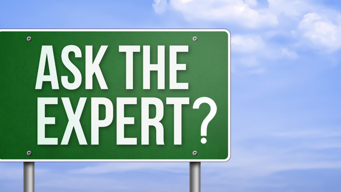 A green sign that says " ask the expert ?"
