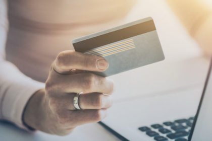 A person holding a credit card in their hand.